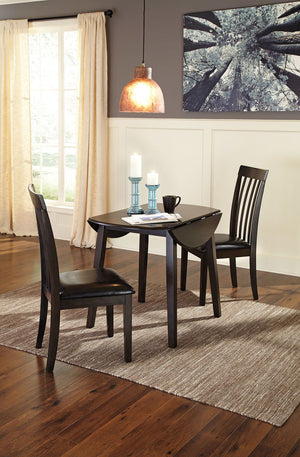 Made with select birch veneer and hardwood solids in a transitional dark brown finish with gray undertones. Compact table seats four and includes drop leaves for multi-function. <h4><b>Hammis - Dark Brown - Round DRM Drop Leaf Table</b></h4> <table width=