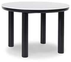 Clean lines meet cool curves with this dining table. Chunky round post legs and a black finish lend a modern vibe, while a replicated white marble top completes the casual lifestyle design. What a delicious choice for a dining room update.<br><br><b>Addit