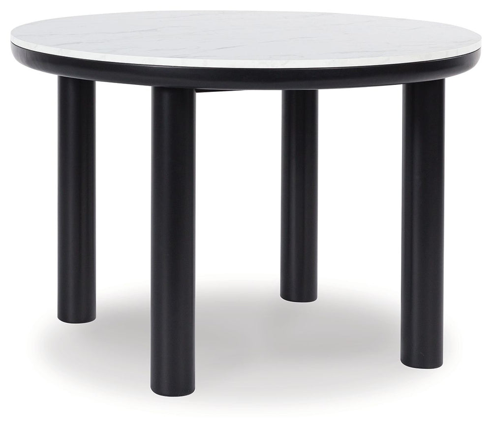 Clean lines meet cool curves with this dining set. Chunky round post legs and a black finish lend a modern vibe, while chairs with softly textured upholstery tempt you to sit and stay awhile. What a delicious choice for a dining room update. <h4><b>Xandru