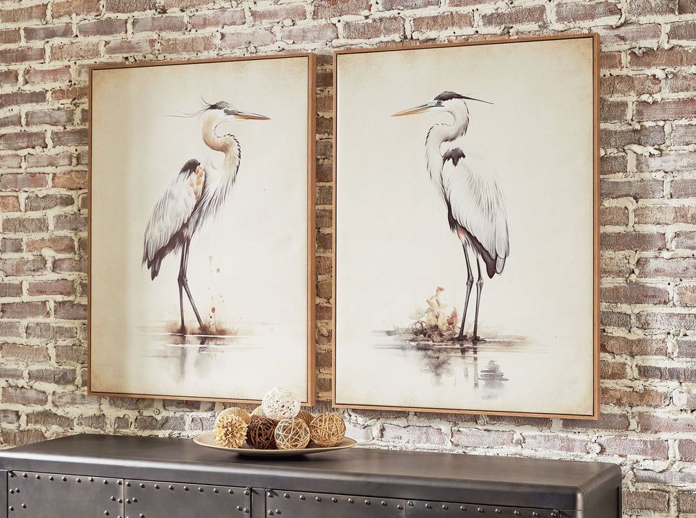 This captivating wall art set depicts majestic herons gracefully surveying their surroundings. A subtle off-white background and neutral shades suit a variety of spaces, from casual to coastal.<br/><br/><b>Product Features</b><ul><li>Set of 2</li><li>Fram
