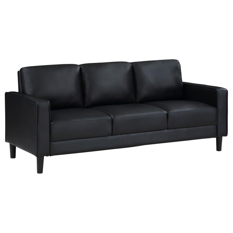 Establish the foundation of a stylish living room with a modern sofa. Smooth faux leather creates a sleek, neutral look that brims with sophistication. Track arms create a structured silhouette, offering tailored flair with an understated ambiance. Straig