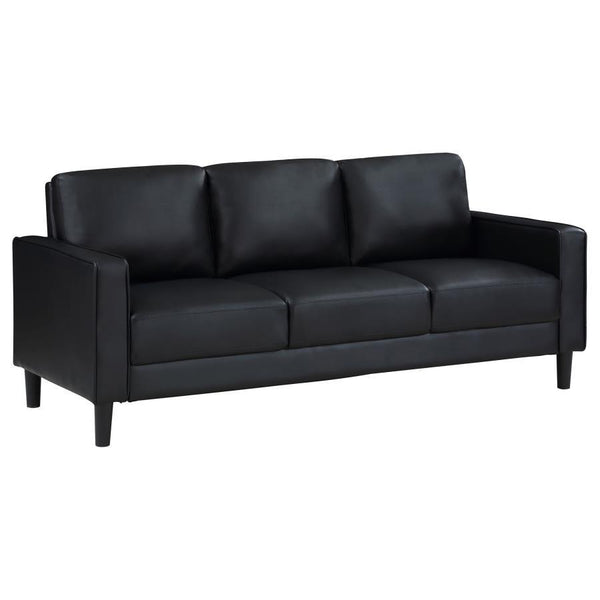 Establish the foundation of a stylish living room with a modern sofa. Smooth faux leather creates a sleek, neutral look that brims with sophistication. Track arms create a structured silhouette, offering tailored flair with an understated ambiance. Straig