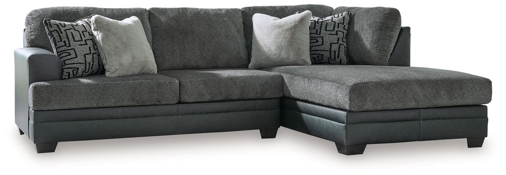 Appeal to your eye for ultra-contemporary design with this sectional. Chic and sleek in dark neutrals, it pairs cozy fabric with faux leather for invitingly cool character. And with a roomy chaise offering extra seating space, family and friends can chill