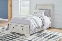 Elegant, timeless furnishings take your bedroom to the next level. Nothing does that better than this twin sleigh bed with storage footboard. The antiqued white finish with a wonderful grain texture radiates sophistication, while drawers with dark bronze-