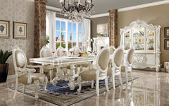 Irresistibly inviting, the Versailles collection displays the unrivaled beauty of the traditional dining. The dining table reflects highly decorative base with oversized scrolled feet, and the upholstered and tapestried chairs with deep button tufted and 