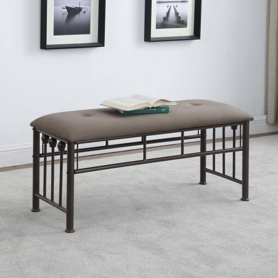 Add versatile seating to your home with this farmhouse-inspired metal bench. Designed with a sturdy dark bronze powder-coated frame, it includes a softly cushioned seat upholstered in brown microfiber for added comfort. Vertical rods and ball accents echo
