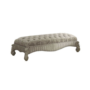 The Versailles Bench presents a hand-crafted piece inspired by the most luxurious designs of the past. The stunning upholstered ottoman comes in a bone white finish and features an ivory fabric button-tufted seat. Nailhead trim accent and elaborate carvin