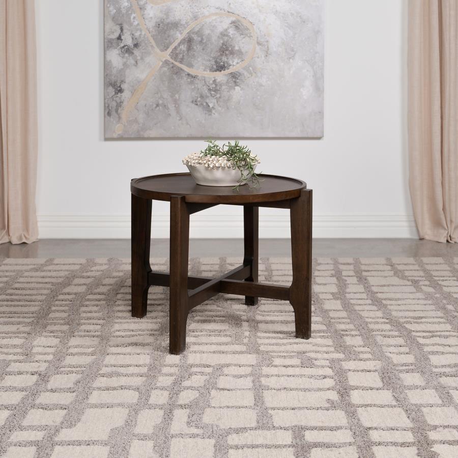 The end table, with its solid wood grandeur and dark brown allure, stands as an intimate alcove in the canvas of the living room. Its round top, bordered by a subtle recess, cradles your evening reads and cherished mementos, a testament to its thoughtful 