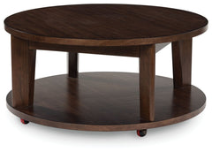 It-'s hard to say what-'s most striking about this round coffee table. Is it the rich warm brown finish or the thick tapered legs? Either way, the table-'s clean, contemporary aesthetic is perfect for your casual lifestyle. Casters let you roll the coffee