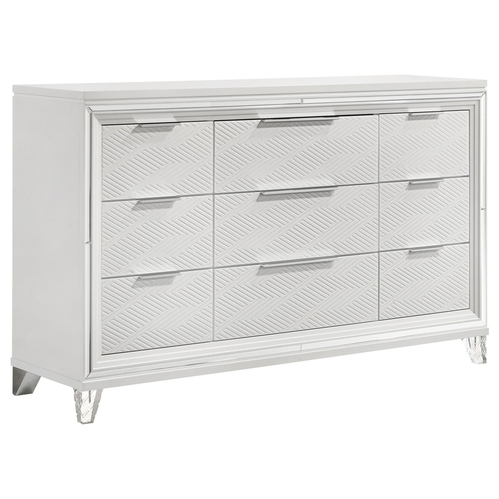 Add a touch of elegance to your bedroom with this spacious 9-drawer dresser, featuring a modern Italian design. The white finish, combined with picture framed recessed panels and embossed herringbone graphic patterns, creates a sophisticated look. Accente