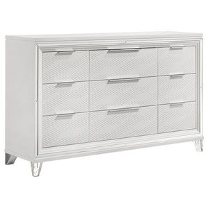Add a touch of elegance to your bedroom with this spacious 9-drawer dresser, featuring a modern Italian design. The white finish, combined with picture framed recessed panels and embossed herringbone graphic patterns, creates a sophisticated look. Accente
