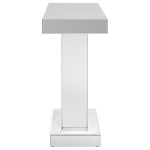  designed to impress with its striking silhouette and luxe materials. The silver mirrored finish is paired with a geometric W-shaped base