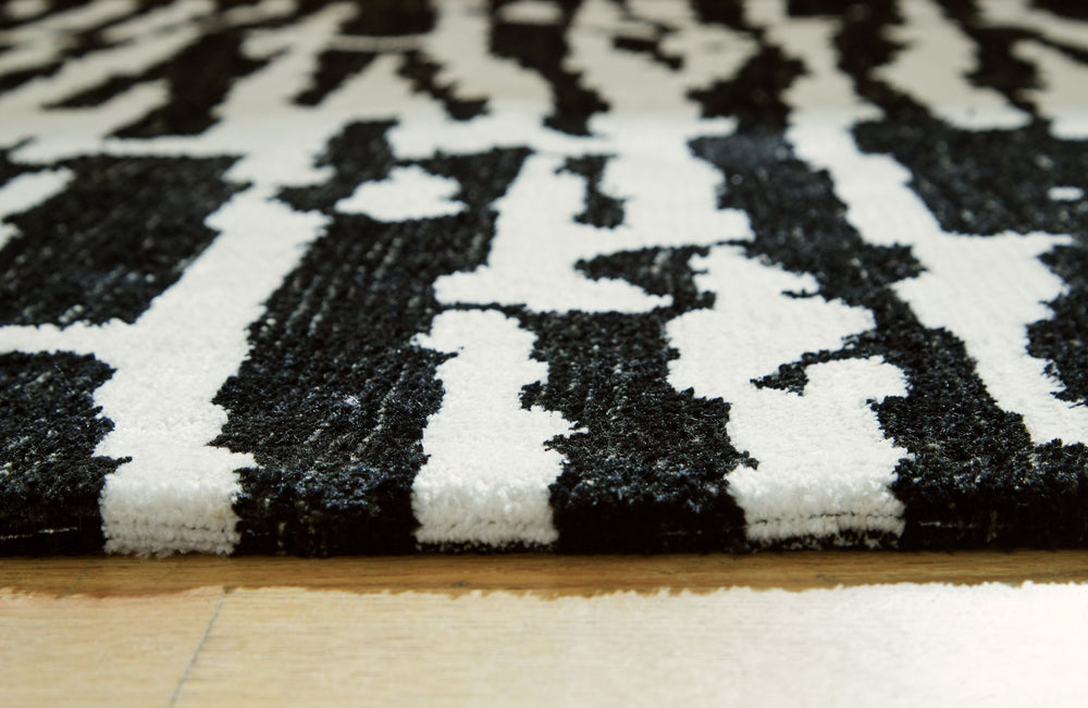 Revitalize your decor with this captivating rug. Infusing your surroundings with style, its abstract motif and rich neutral colors create the perfect pop of interest.<br/><br/><b>Product Features</b><ul><li>Made of polyester</li><li>Machine woven</li><li>