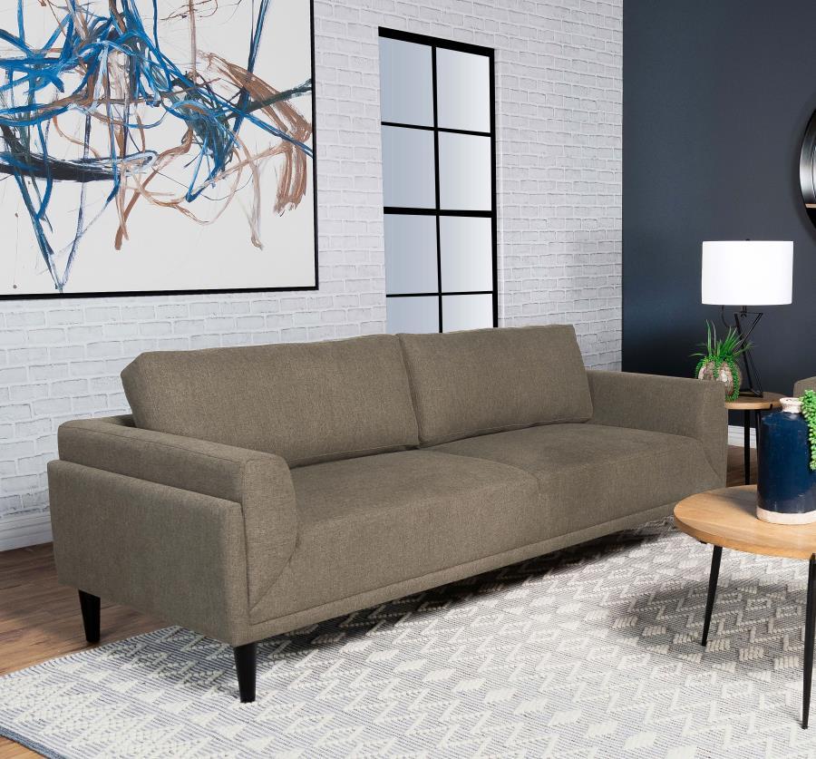 Unveiling our modern sofa, where innovation meets elegance in a frame within a frame design. Adorned in a chic fabric, its streamlined silhouette is highlighted by meticulous topstitch details and track arms complemented by mitered front accents. Prioriti