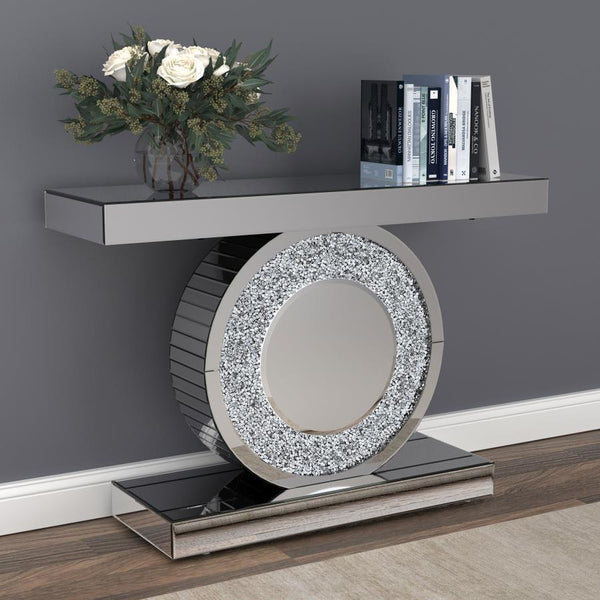  it showcases a sculptural circular base encrusted with glittering silver crystals. The sleek rectangular top an