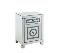 The Noralie Accent Table will give any room a touch of glamour. Mirror and glass materials give it a modern and clear touch while faux diamond inlays add glam style to this piece. Use this unique piece as the perfect accent for any room dÃ©cor. It has a s