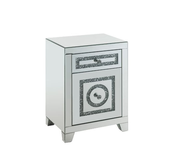 The Noralie Accent Table will give any room a touch of glamour. Mirror and glass materials give it a modern and clear touch while faux diamond inlays add glam style to this piece. Use this unique piece as the perfect accent for any room dÃ©cor. It has a s