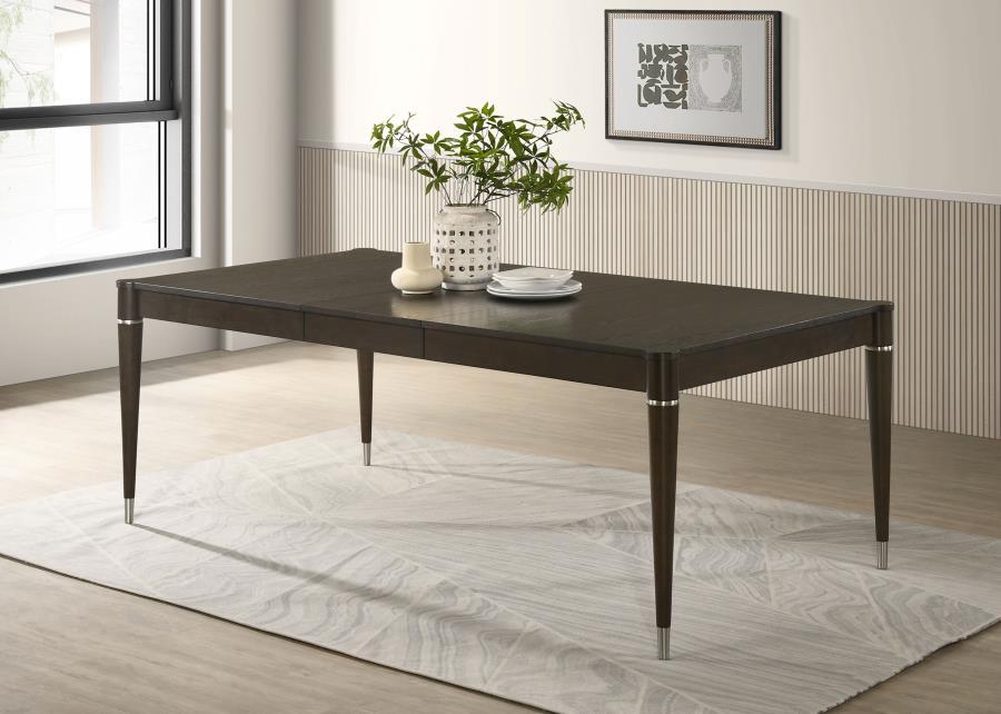 Enhance your dining experience with this contemporary dining table in a stunning ash brown finish. Crafted with a combination of engineered wood, Asian hardwood, and ash veneer, it delivers durability and timeless elegance. The table extends from 63 inche