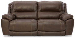Load up on comfort in a cool, clean-lined and contemporary way with this power reclining loveseat in chocolate brown. Rest assured, the expertly matched leather and faux leather upholstery is enriched with a pebble grain effect for authentic appeal and en
