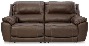 Load up on comfort in a cool, clean-lined and contemporary way with this power reclining loveseat in chocolate brown. Rest assured, the expertly matched leather and faux leather upholstery is enriched with a pebble grain effect for authentic appeal and en