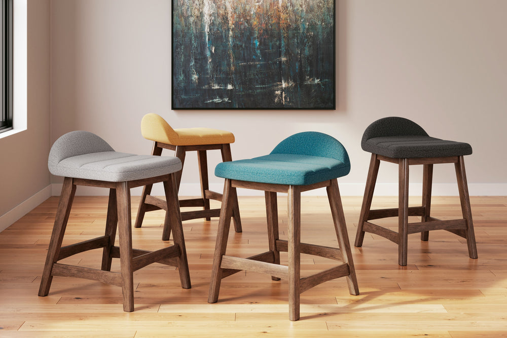A refreshed take on retro aesthetics. This upholstered bar stool adds an air of playful simplicity to your dining space, capturing the architectural language of mid-century stylings. The seat invites the eye with a soft-edged silhouette and chic blue cush