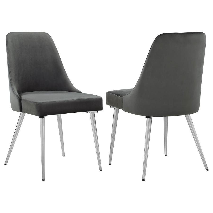 This modern dining chair blends sleek design with luxurious comfort, making it a perfect addition to any dining space. Upholstered in soft grey velvet, the plush padded seat and curved backrest provide a supportive and inviting feel. Tapered metal legs in