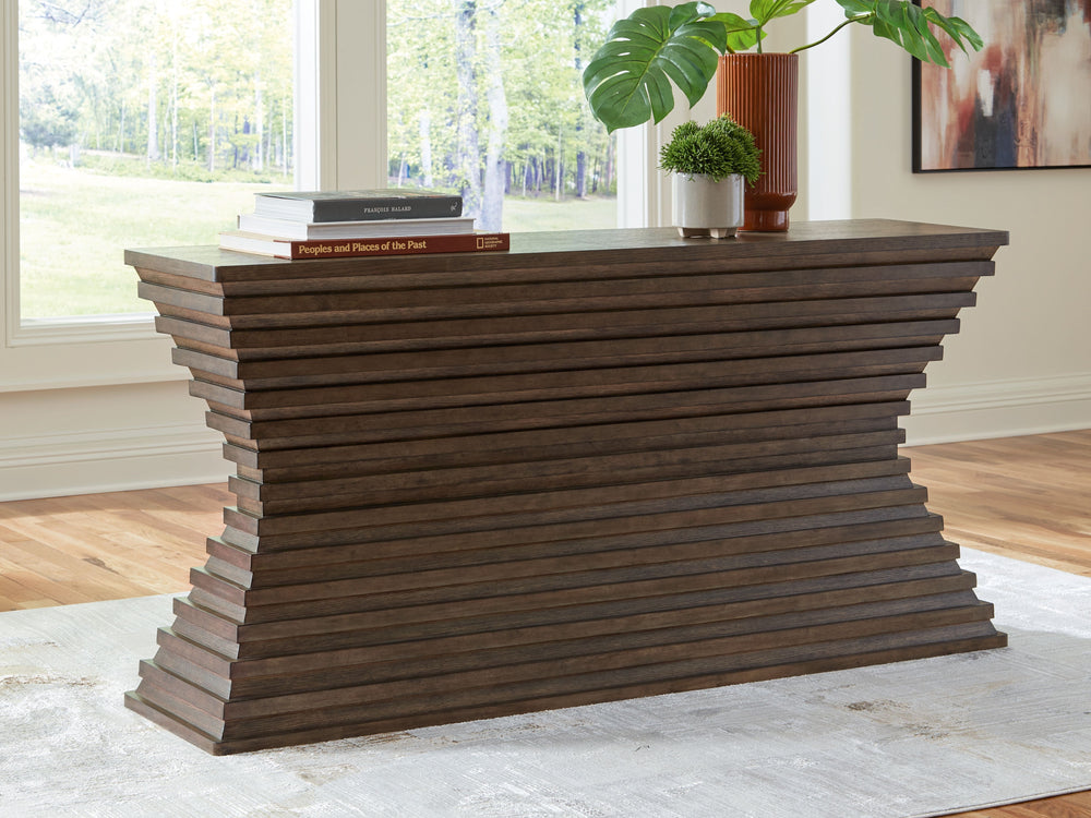 A statement-making table? Yes, please. The distinctive silhouette of this sofa table is sure to captivate lovers of contemporary design. Featuring head-turning architectural geometry and a rich, inviting warm brown finish, this piece is ready to take your