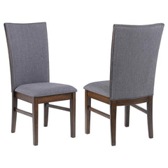 This elegant dining side chair combines comfort and sophistication, making it the perfect complement to any dining table. Upholstered in soft gray fabric on both sides of the backrest and the seat, it offers a cohesive and refined look. The sturdy frame i