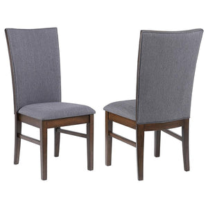 This elegant dining side chair combines comfort and sophistication, making it the perfect complement to any dining table. Upholstered in soft gray fabric on both sides of the backrest and the seat, it offers a cohesive and refined look. The sturdy frame i
