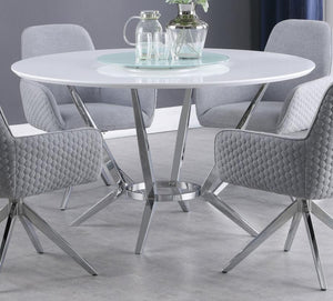  this round dining table pairs a high gloss white top with a tempered glass lazy Susan for added function. Its metal base features boomerang-style legs finished in electroplated chrome