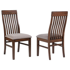 Punctuate a stylish dining table ensemble with a set of two modern side chairs. Each features a solid, stately silhouette with a mango oak wood finish that-'s dark and rich, perfect for friends and family alike. The chairs features tall, slatted backs, wi