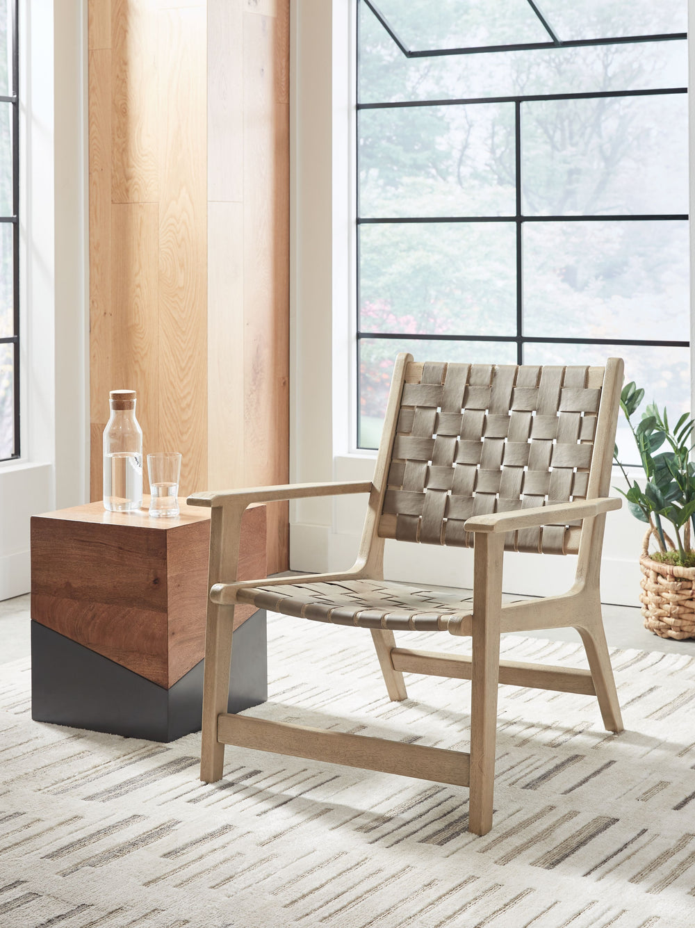 Express your sense of contemporary yet comfortable style with this accent chair. The on-trend frame is accented by taupe leather strips in a basket weave pattern for a mid-century modern aesthetic. Tuck this gem into your living room or home office for a 