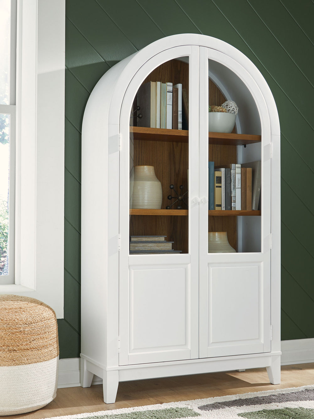 This accent cabinet is proof positive that style and storage can go hand in hand. Doors with glass fronts invite you to create a charmingly curated display of your favorite china and decor pieces. And the cool curves of its arched design add an inviting a