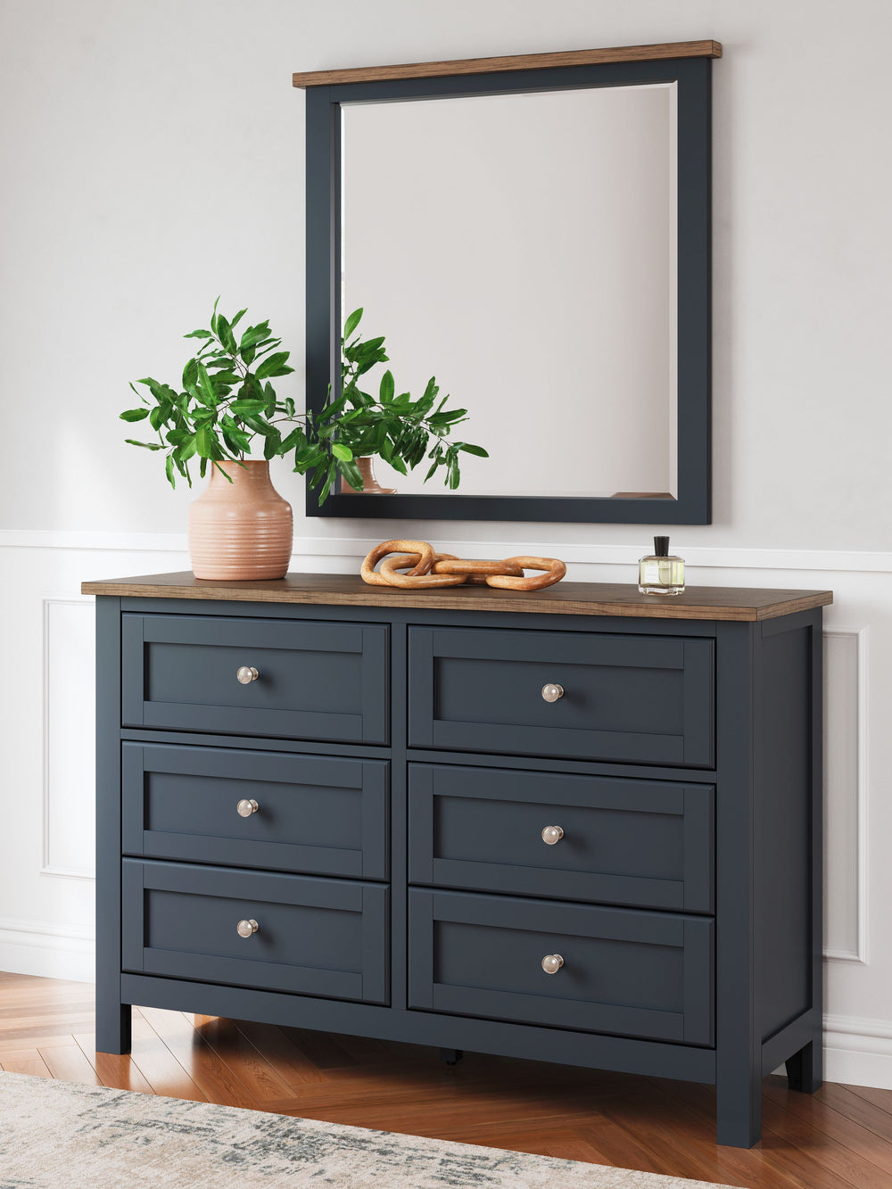 Add homespun charm to your restful retreat. A modern take on a timeless silhouette, this dresser and mirror set pairs a dark slate blue finish with a light brown top. Drawer fronts and legs in a classic Shaker style bring an air of beautiful simplicity to