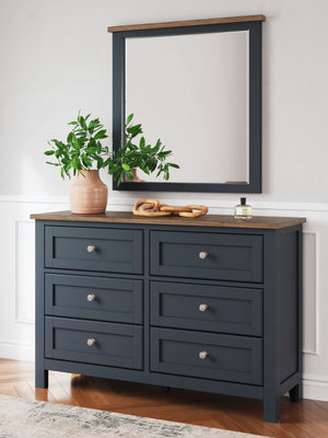  this dresser and mirror set pairs a dark slate blue finish with a light brown top. Drawer fronts and legs in a classic Shaker style bring an air of beautiful simplicity to
