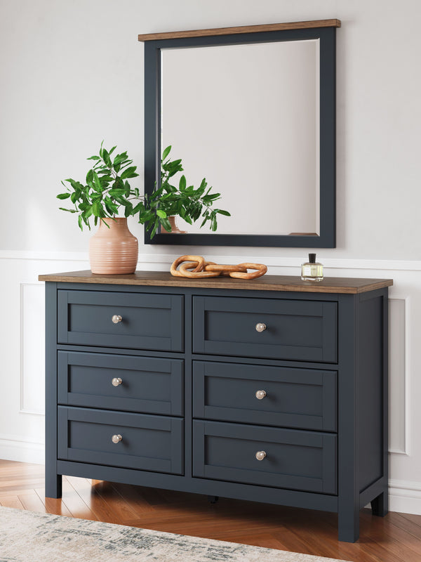  this dresser and mirror set pairs a dark slate blue finish with a light brown top. Drawer fronts and legs in a classic Shaker style bring an air of beautiful simplicity to