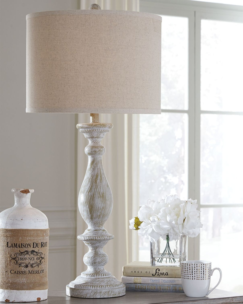 With its whitewash finish, this table lamp is full of character and style. Its candlestick design and drum shade will add a dose of casual chicness to your living space.<br><br><b>Additional Dimensions</b><br><ul><li>Shade: 0-"</li><li>Base: 0-"</li><li>C