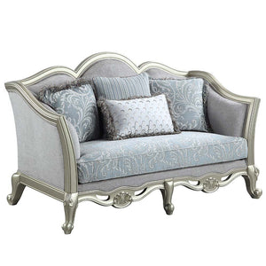 With a timeless silhouette influenced by French beauty, this Qunsia sofa makes a gracious statement in a comforting light gray linen upholstery fabric. Delicate curves invite the eye, while cabriole legs the champagne wooden trim that adds visual impact. 