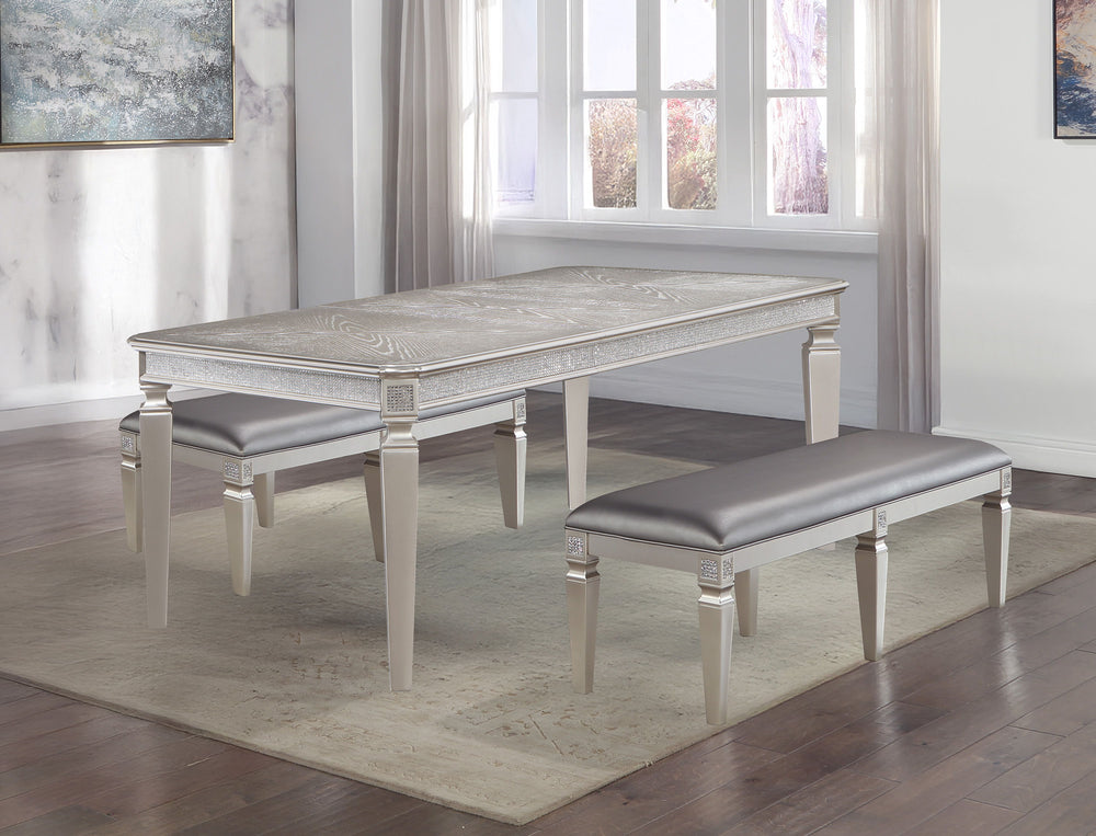 Make a bold statement in your dining space with this glamorous and sophisticated dining group, designed to bring luxury and elegance to every gathering. The sleek table features exquisite detailing along its edges, complemented by a shimmering finish that