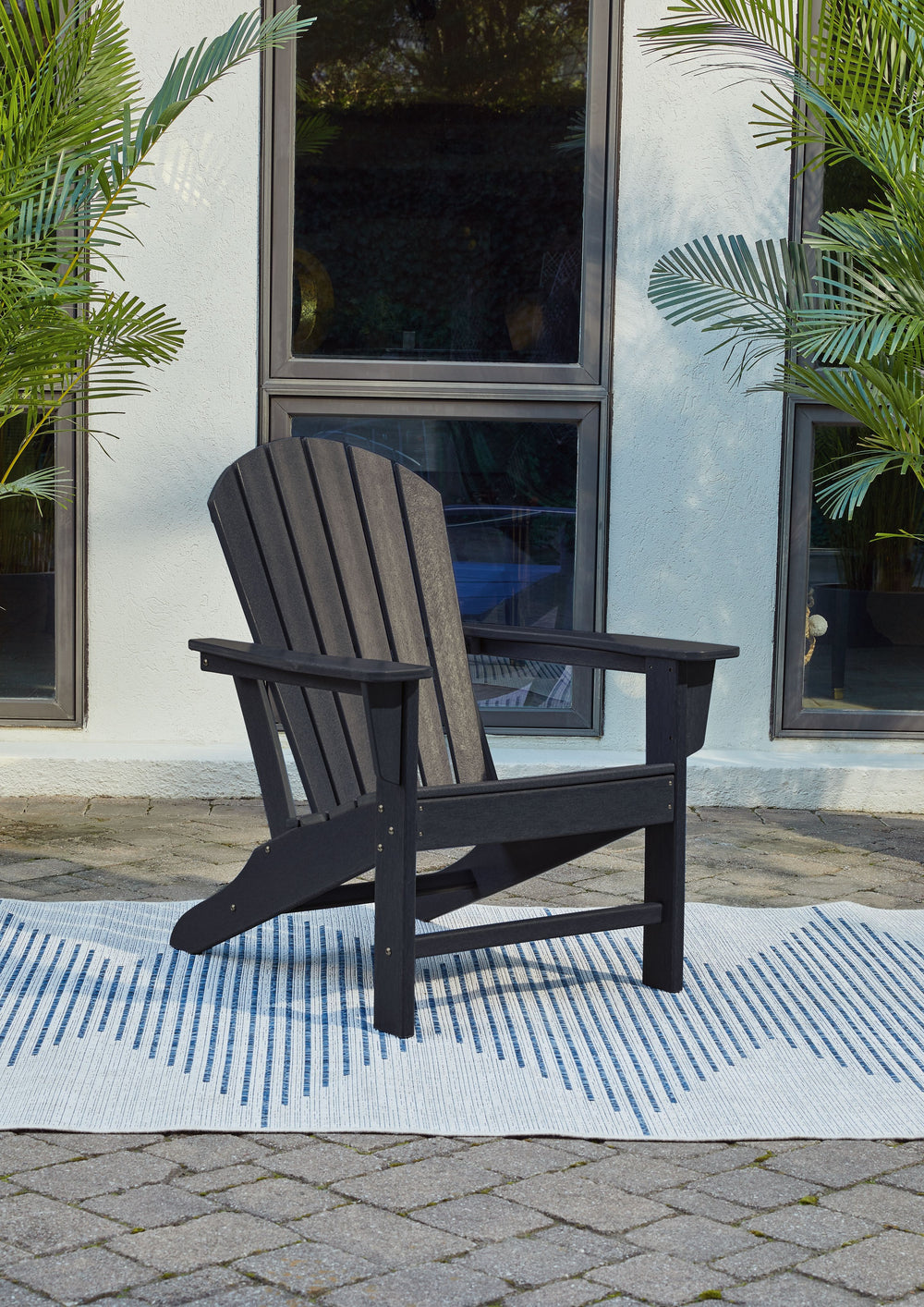 Add cottage-quaint charm to your outdoor oasis with this Adirondack chair in black. Made of MEGA-TUFFÂ® high-density polyethylene material, itâ€™s sure to weather the seasons beautifully. Designed to shed rainwater, the chairâ€™s slatted styling with shel