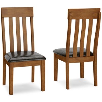 Comfortably contoured, with a rake back design, this dining room upholstered side chair beautifully captures the essence of rustic refinement. Plushly upholstered faux leather seat makes pulling up a chair so much more enticing. Makes for easy cleanup, to