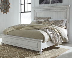 Give your retreat vintage charm with this king panel bed. In a beautifully distressed whitewash finish, you-'ll love the headboard-'s grand style featuring a picture framed panel. Generously scaled moulding from top to bottom, along with bun feet give thi
