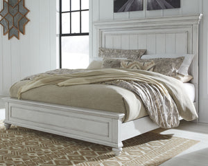 Give your retreat vintage charm with this king panel bed. In a beautifully distressed whitewash finish, you-'ll love the headboard-'s grand style featuring a picture framed panel. Generously scaled moulding from top to bottom, along with bun feet give thi