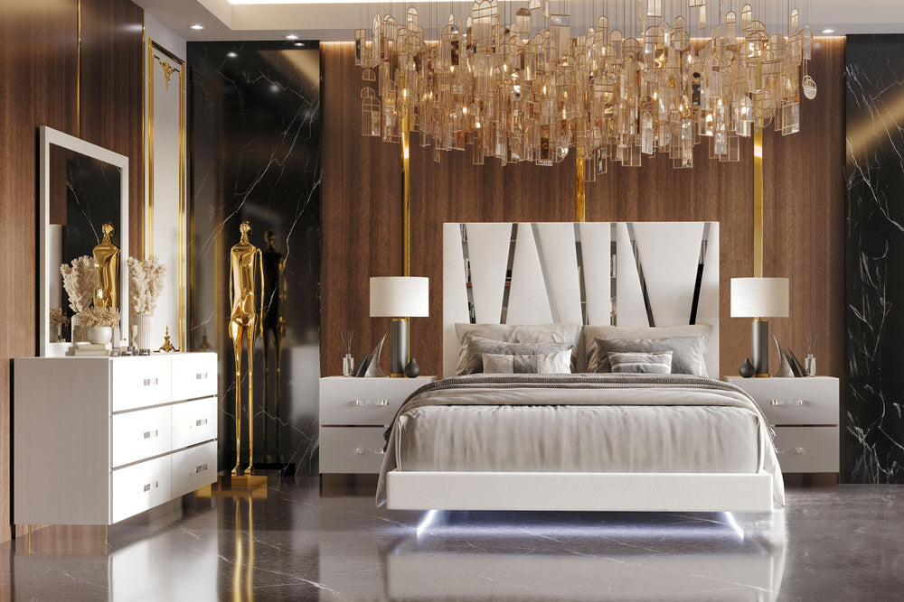 The Europa 5 Piece Bedroom Set in white offers a blend of modern sophistication and practical functionality. This set includes a panel bed along with a dresser, mirror, and two nightstands. The sleek design is highlighted by the majestic headboard, glossy