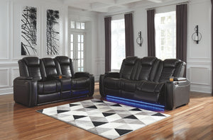This power reclining set takes its cue from luxury automobiles with lattice- and cross-hatch stitching, for a richly tailored aesthetic that gives you plenty of reasons to celebrate. Sumptuously padded cushions and dramatic midnight black faux leather uph