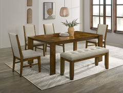Transform your dining space into a haven of warmth and style with this stunning ensemble, perfect for both casual and formal settings. The tailored chairs and tufted bench are upholstered in a soft neutral fabric, providing luxurious comfort and a modern 