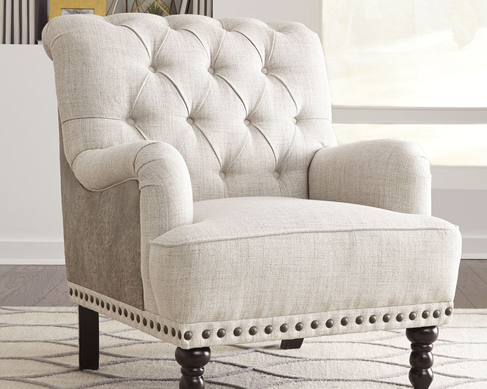 Fresh and sophisticated. This accent chair with button tufting is a classy addition to your home. Inside-out design with linen weave fabric on the seating area and taupe faux leather on the back. Large nailhead trim ties the look together. Charles of Lond