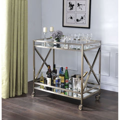 The Kristensen serving cart offers both functionality and superiority for any space in your home. The openwork metal frame finished in antique brass with two-tiered mirror design and the four caster wheelbase effortlessly rolls around. Stack up glossy art