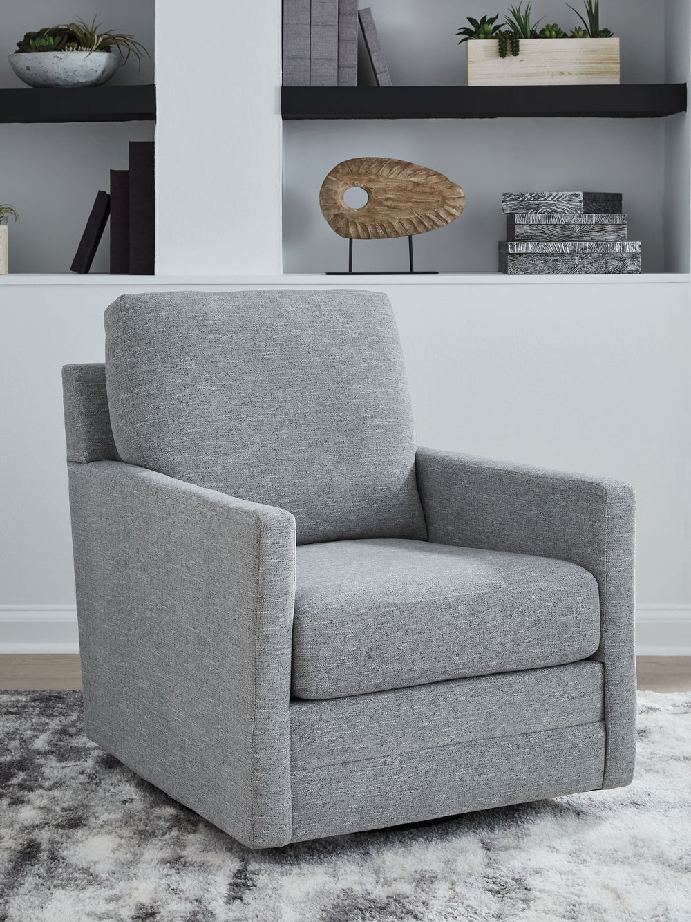 Your love for low-maintenance lounging can take an unexpected turn with this Next-Gen Nuvellaâ„¢ swivel accent chair. Upkeep is a breeze thanks to its stain-resistant performance fabric. The neutral pewter upholstery blends easily with your other decor, w