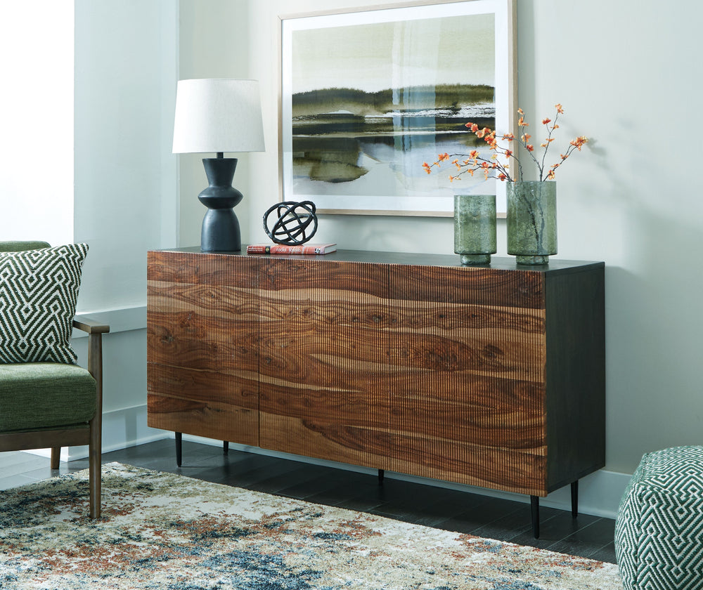 This mid-century modern inspired piece is skillfully crafted with durable solid mango and shesham wood. The natural and deep brown finish in addition to the fluted, grooved door fronts provide character anywhere itâ€™s displayed. Pair it with sumptuous ve